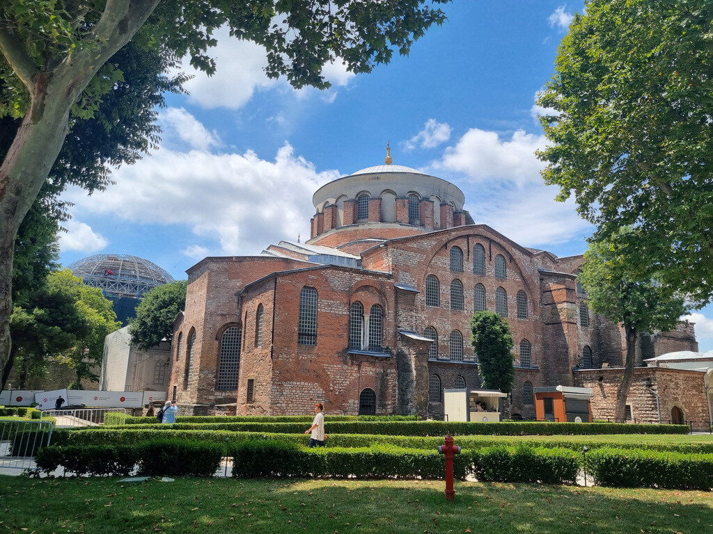 Hagia Irene, the most prominent monument in the First Courtyard of Topkapı Palace, with the scaffold-covered Hagia Sophia rising behind it during restoration. photo by Serhat Engul